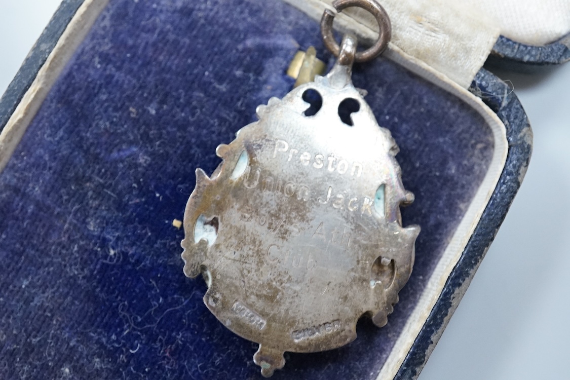 Framed group of eight WWI and WWII medals including a First World War medal pair, the Africa star, the Atlantic star, etc. a hallmarked silver boxing medal and another, both cased, plus a Lancashire and Cheshire Associat